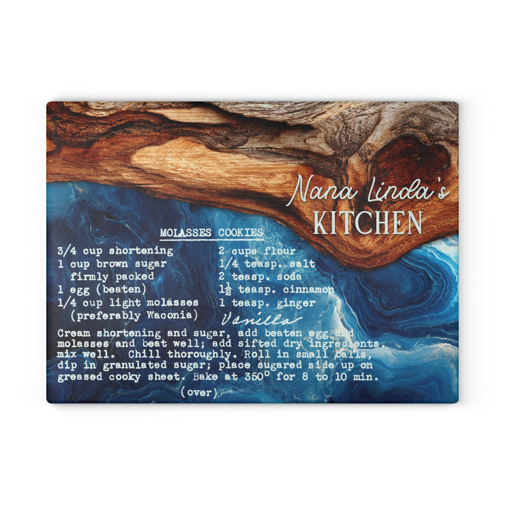 A rectangular decorative sign or print featuring a rustic wood-and-water background with the text 'Nana Linda's KITCHEN' and a cookie recipe printed below in white script and block lettering.