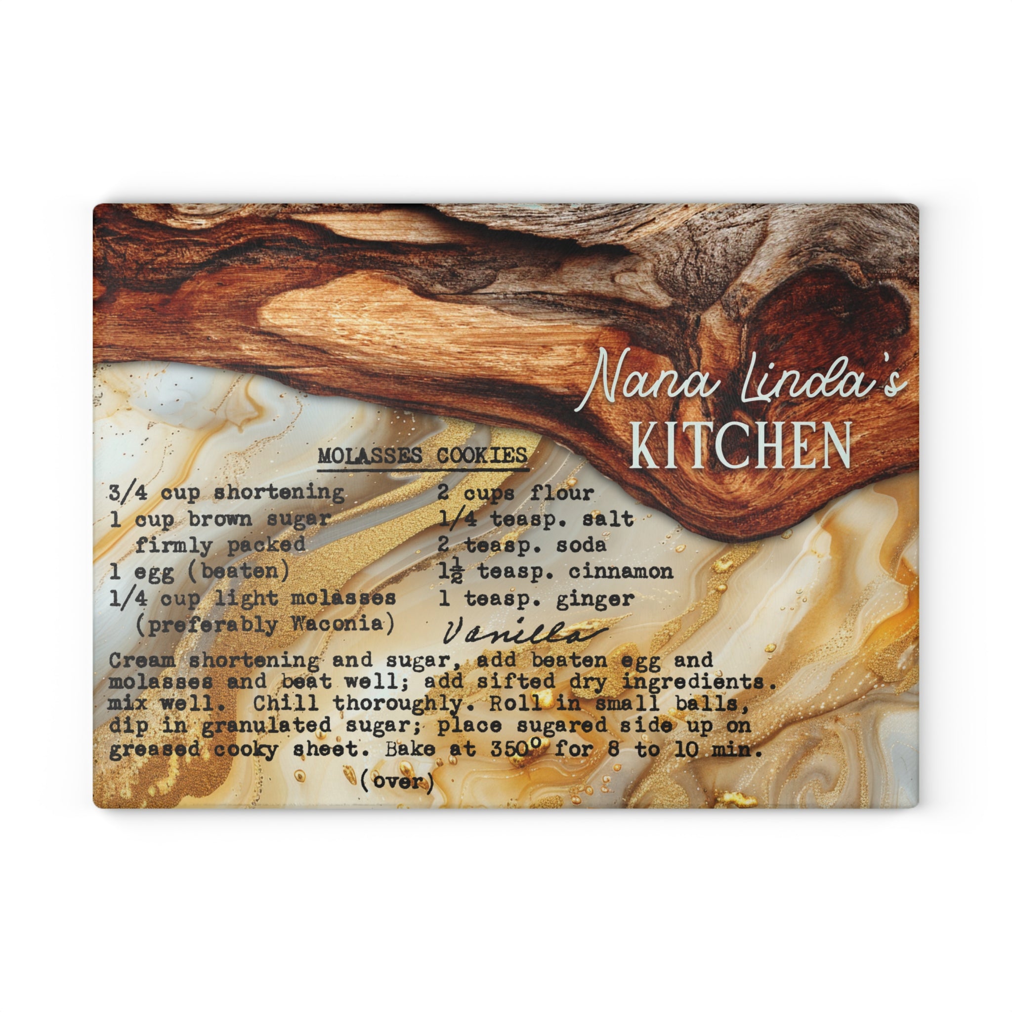 A square decorative recipe card or print titled 'Nana Linda's Kitchen' showing a vanilla molasses cookie recipe in black text over a marbled wood-and-gold background with a wooden spoon illustration.