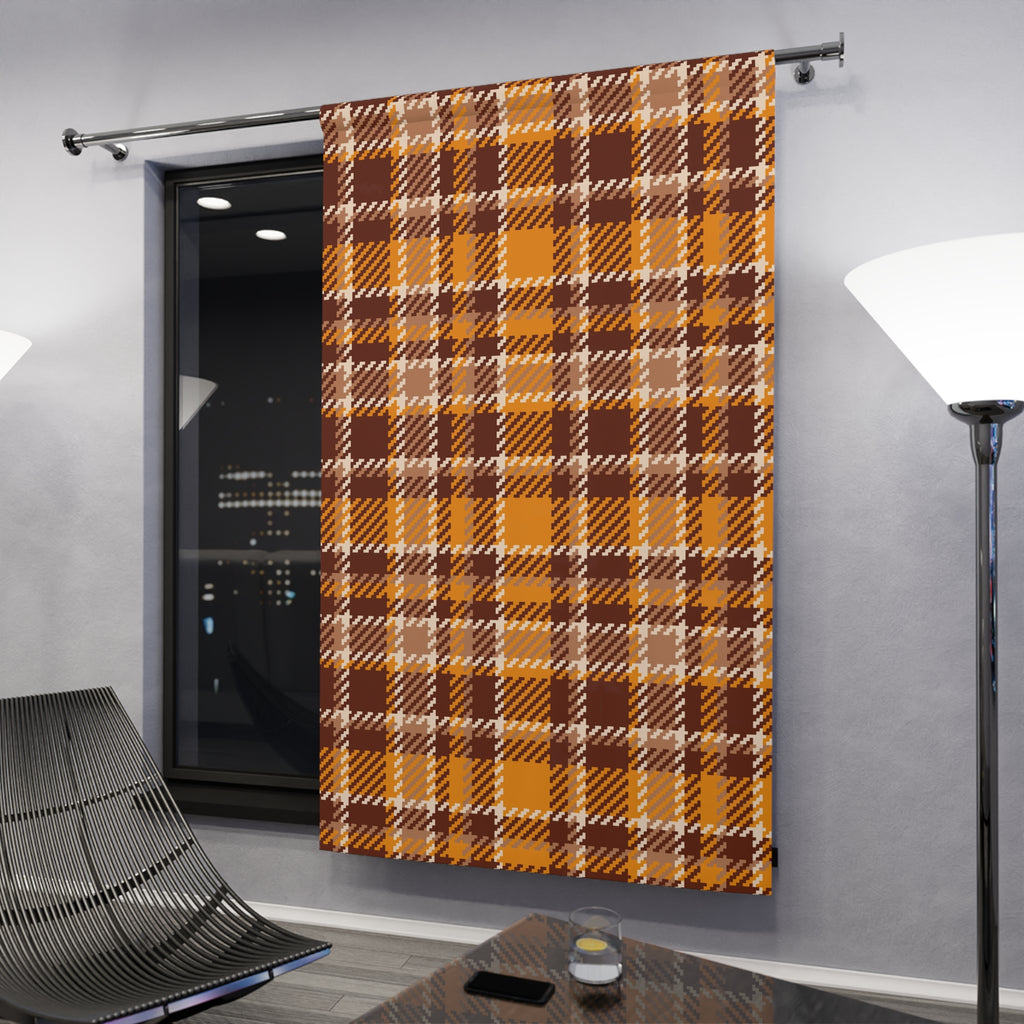 A single window curtain panel hanging on a metal rod in a modern room. The curtain has an autumn plaid pattern in mustard yellow, brown, and beige.