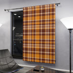 A single window curtain panel hanging on a metal rod in a modern room. The curtain has an autumn plaid pattern in mustard yellow, brown, and beige.