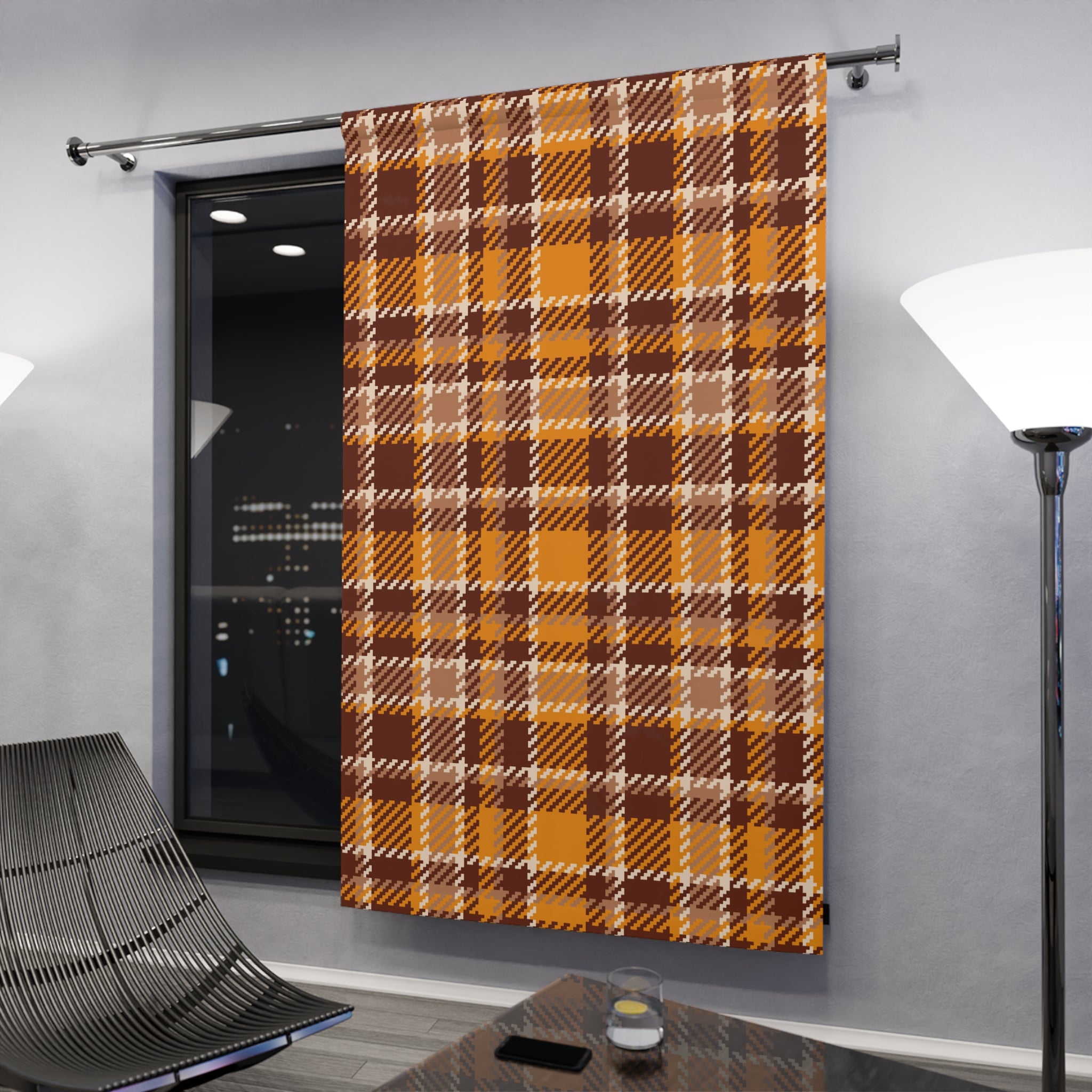 A single window curtain panel hanging on a metal rod in a modern room. The curtain has an autumn plaid pattern in mustard yellow, brown, and beige.