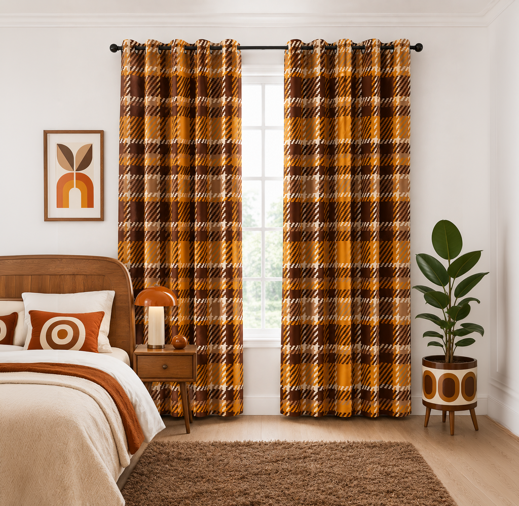 A pair of long window curtains in a warm mustard yellow, brown, and black plaid pattern, hanging on a black rod in a styled bedroom setting.