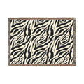 Zebra patterned throw blanket on a white background