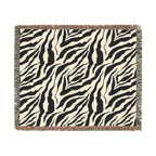 Zebra patterned throw blanket on a white background