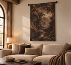 A large vertical wall tapestry featuring a classical landscape painting of a forest path, styled in a cozy living room above a beige sofa.